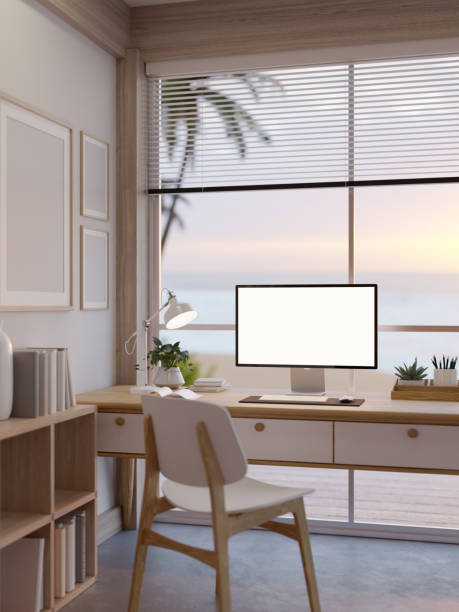 istock A desktop computer on a table in a beautiful minimalist coffee shop with high glass ceiling and wall. 1803194591