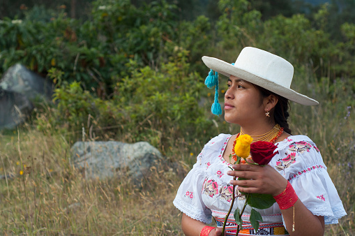 copy-space of young indigenous woman from ecuador with traditional dress and ancestral hat in nature.hispanic heritage month. High quality photo
