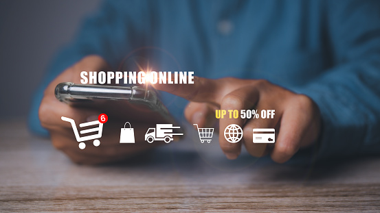 Man using mobile phone shopping online with icons E-commerce marketing business online. Internet Technology, online shopping, business delivery e-commerce, service on the online web.