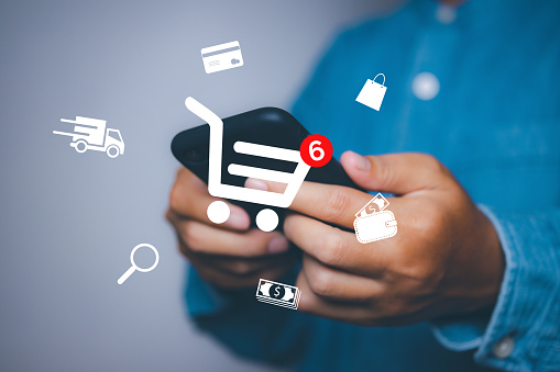 Man using mobile phone shopping online with icons E-commerce marketing business online. Internet Technology, online shopping, business delivery e-commerce, service on the online web.