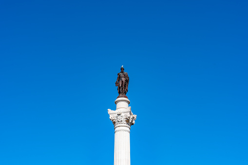 Statue of Caco the one present in the tenth labor of Hercules and in the back the column with a winged lion on square of liberty in Udine Italy