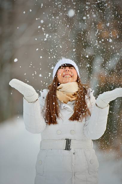 istock Woman playing with snow 180328228