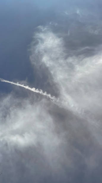 istock Blue sky and vapor trail on a slightly cloudy day 1803286173