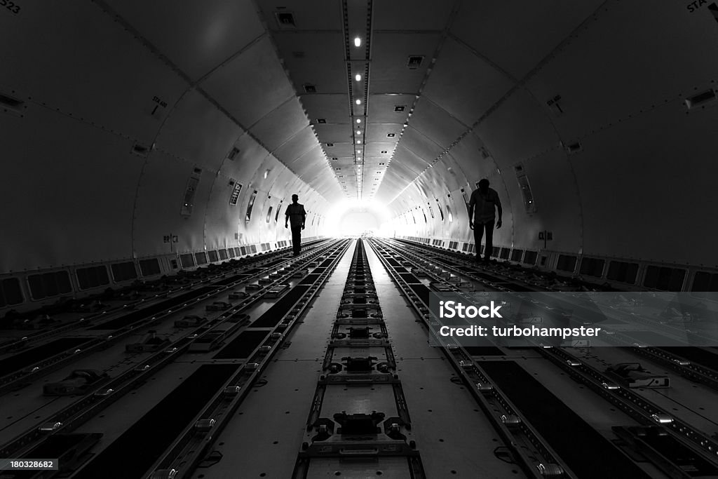 Cargo hold 2 men in a cargo hold of an aircraft Airplane Stock Photo