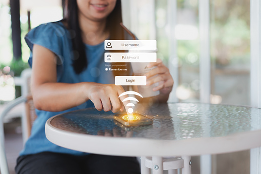 Hand touching on smartphone login register username and password identity on virtual screen from on internet security access in cafe. Internet access, join social, personal data protection concept.