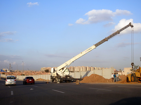 Cairo, Egypt, November 14 2023: A mobile crane at a construction site, a tough and ready workhorse, for lifting and material processing products and services, Terex crane mobile vehicle for lifting, selective focus