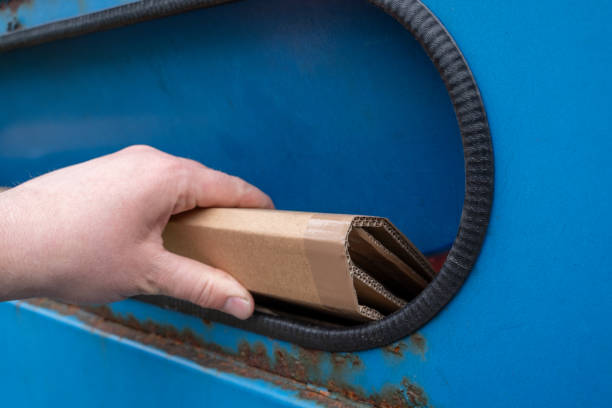 istock Male hand throw cardboard in paper container 1803307371
