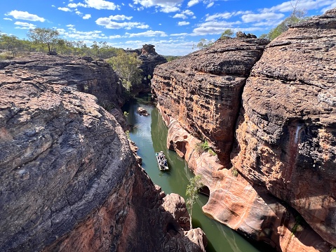 Mount Surprised, Qld - May 05 2023:Aerial view of Australian tourists on eco tour cruise in Cobbold Gorge a natural wonder of Queensland's outback Savannah, and the youngest gorge in Australia.