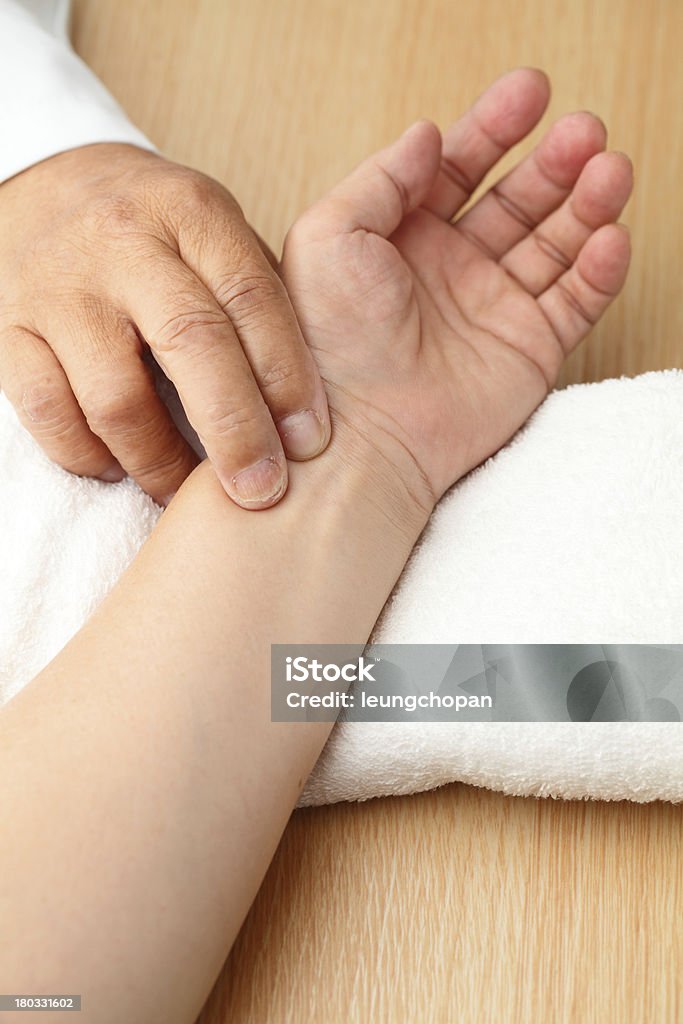 Chinese doctor diagnose pulse of patient China - East Asia Stock Photo