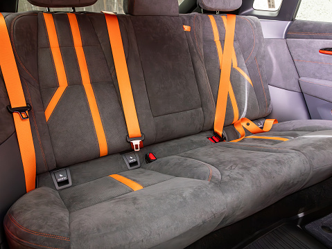 Novosibirsk, Russia -  November 10  , 2023:    Zeekr 001, Clean car interior: black and orange  back seats, headrests and belts