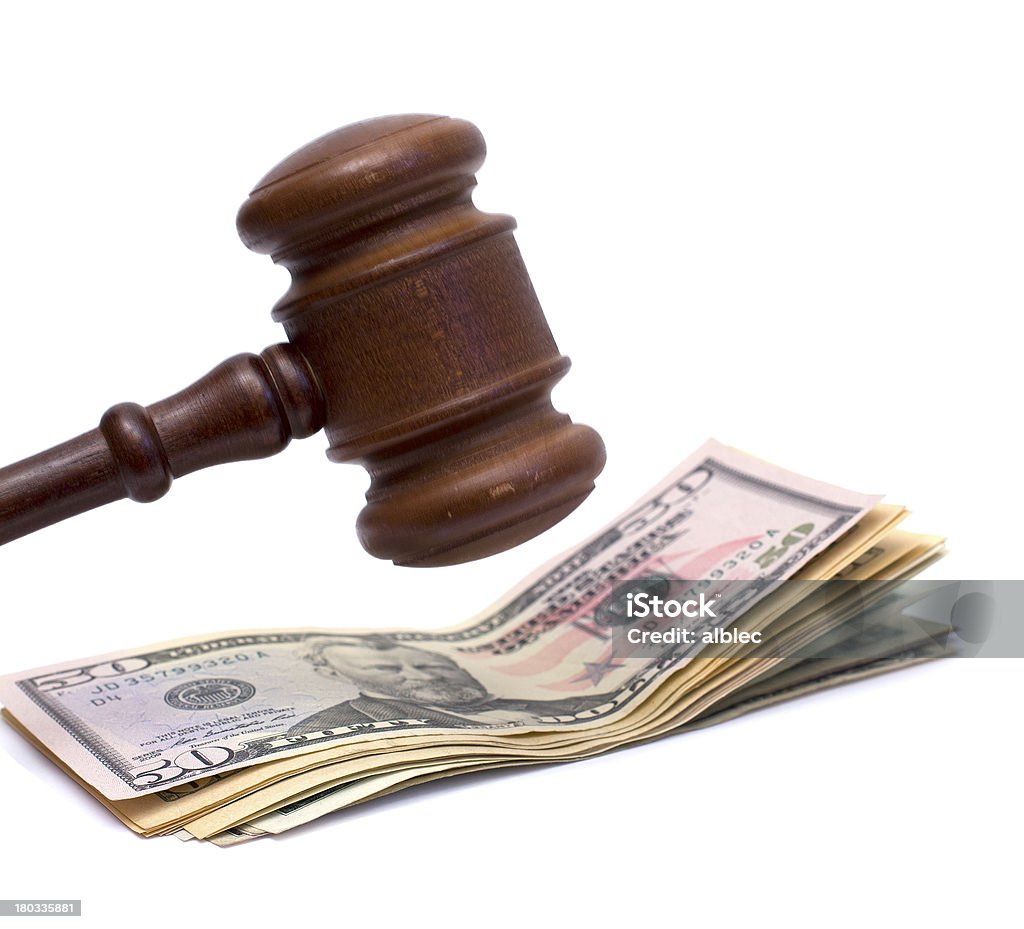 A mallet about it hit bank notes judge mallet and pile of money over white Authority Stock Photo