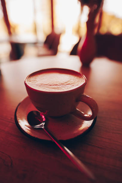 istock A cup of cappuccino on the table in pink cafe 1803362301