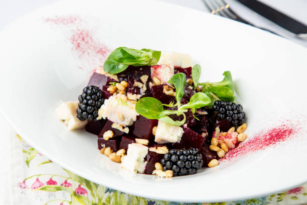 istock salad of blackberries, beets, seeds and cheese, side view on a white plate 1803385363