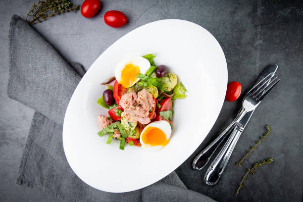 istock salad with soft-boiled egg, tuna, green onions, boiled potatoes, top view 1803390053