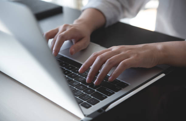 istock Close up, woman hands typing on laptop computer keyboard, surfing the internet on office table, online, working, business and technology, internet network communication concept 1803392154