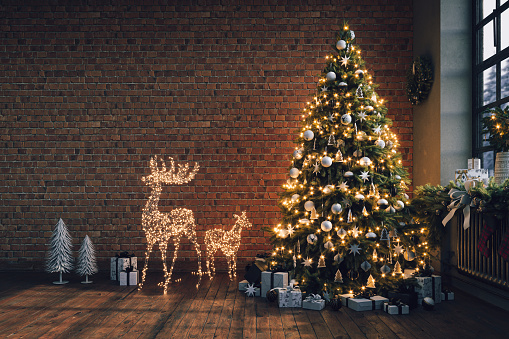 Industrial brick living room interior design with Christmas tree and gift boxes. New Year celebration. Loft Apartment