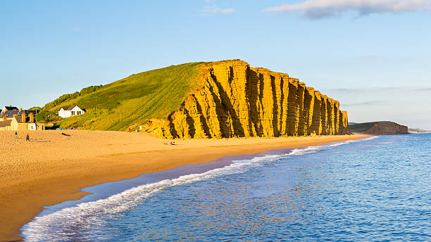West Bay Dorset England Evening light on the golden cliffs at West Bay Dorset England UK Europe dorset england stock pictures, royalty-free photos & images