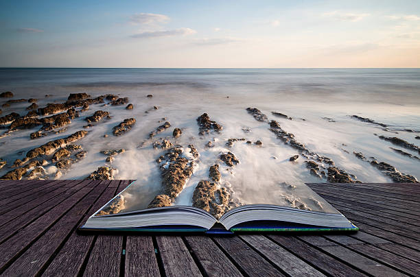 istock Creative concept book Long exposure landscape rocky shoreline 180343555