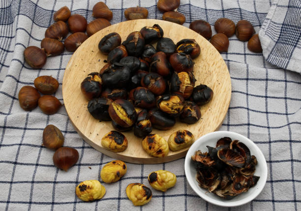 istock Fresh roasted chestnuts on a table with peels. 1803444448