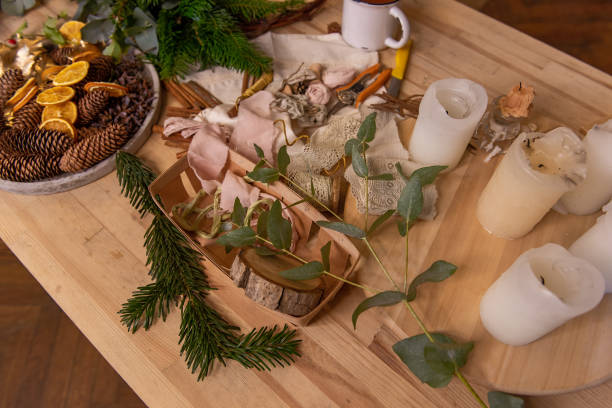 istock On wooden table are rustic materials for creative decoration of Christmas interior. Wreath tutorial 1803448742