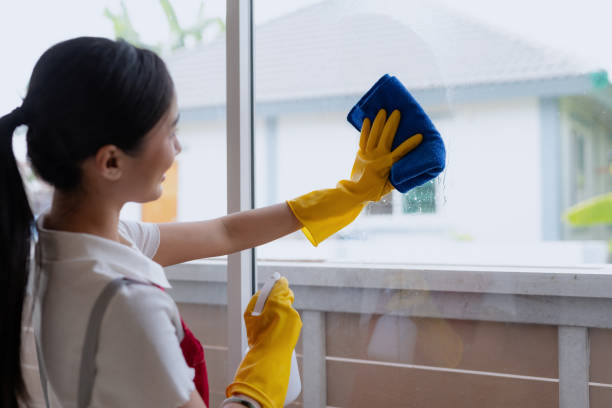 istock Young asian woman cleaning window. 1803453191