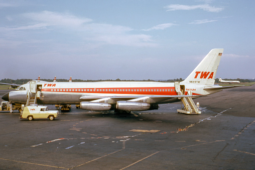 TWA Convair Superjet 880-22-1 airplane parked on airport apron while being serviced between flights. This planes were used for passenger service during the 1960s.