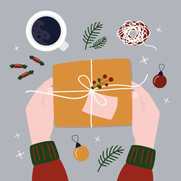 Vector illustration of Woman hands wrapped Christmas gift. Packaging process, present box in wrapping paper, various tools and candy on table. Top view. Xmas and New Year celebration preparation.