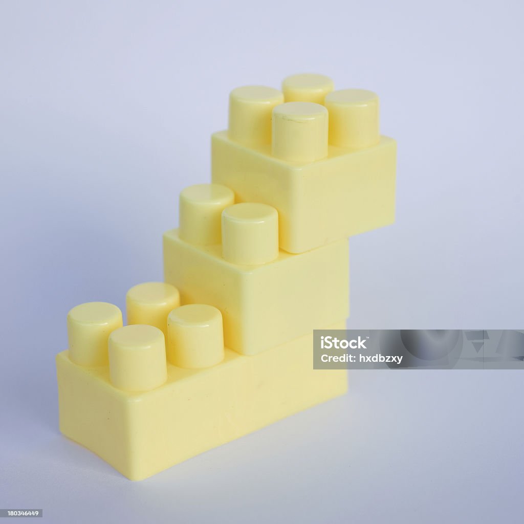 plastic building blocks yellow plastic building blocks on white background Achievement Stock Photo