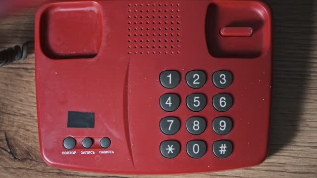 Calling 911 On an Old Retro Red Telephone with Dial Buttons Top View