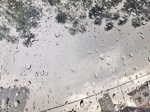 Rain droplets at window in city