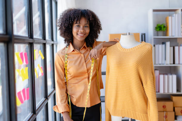 istock Young African American female clothing designer working inside office. 1803474980
