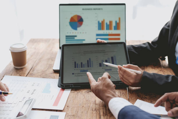istock Business people meeting explaining the financial graph data and marketing plan. Group of Business people meeting and using graphs, charts, presented at company sales strategy marketing meeting. 1803486671
