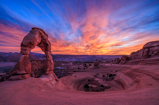 A colorful Southwest sky behind Delicate Arch in Arches National Park, Utah.