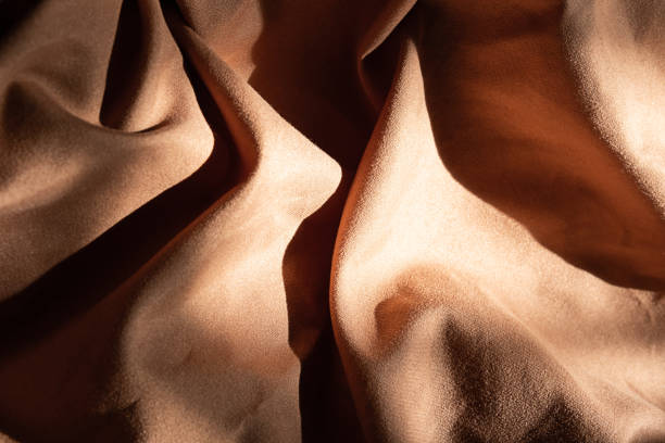 istock Brown textured wavy fabric in hard light. 1803488368