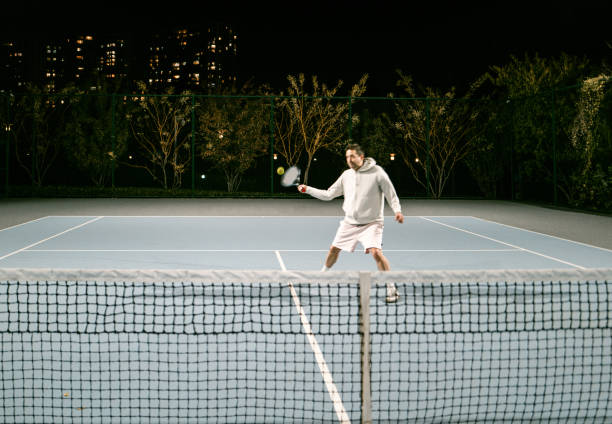 istock Playing Tennis outdoors at night 1803488910