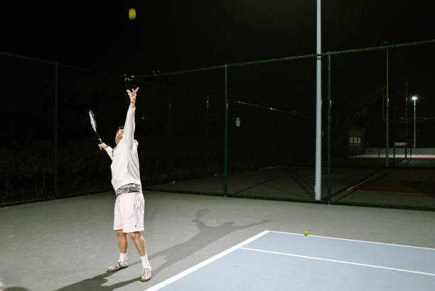 istock Playing Tennis outdoors at night 1803488913