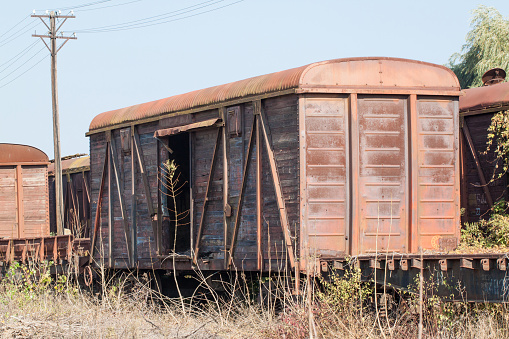 An old covered freight car. An old abandoned railway line.