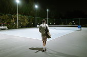 Playing Tennis outdoors at night