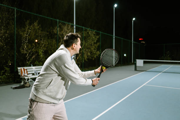 istock Playing Tennis outdoors at night 1803491091
