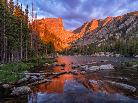 Morning Alpenglow on Hallett Peak and Flattop Mountain reflected in Dream Lake at sunrise in Rocky Mountain National Park, Estes Park, Colorado.