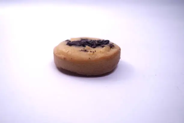 Photo of Kue Cubit is a popular snack in Jakarta, Indonesian version of Dutch poffertjes. Topped with chocolate sprinkles, served on a white plate and isolated on a white background.