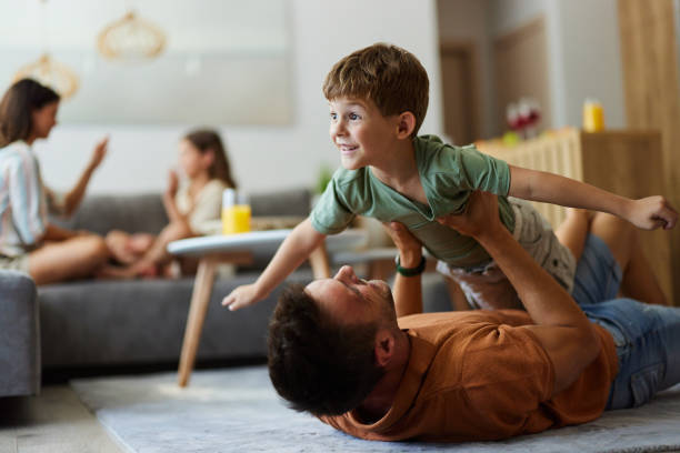 istock Happy boy having fun with his father on carpet at home. 1803520002