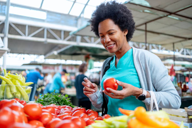 istock Happy female buying fresh tomatoes 1803526049
