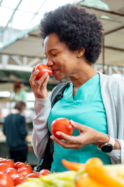istock Medical practitioner smelling tomato in the market. 1803526051