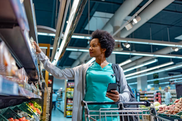 istock Female nurse shopping with smartphone checklist. 1803534808