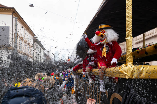 Basel carnival 2023. Waggis throwing confetti Basel, Switzerland - March 1st 2023. Waggis on a float throwing confetti fastnacht stock pictures, royalty-free photos & images
