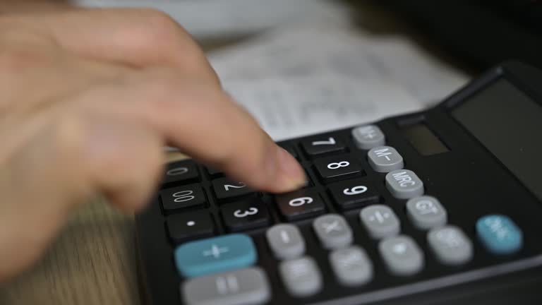 Man's hands using a calculator. Tax time.Tax concept. Close-up.