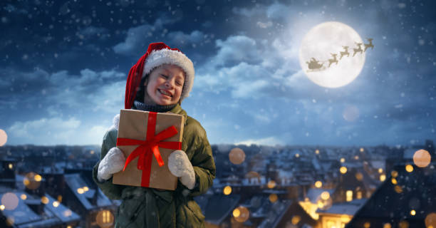 istock girl with present at Christmas 1803563621
