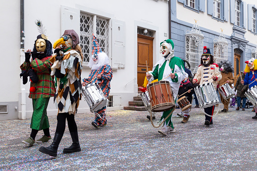 Basel, Switzerland - February 28th 2023. Close-up of a parade group in costumes playing piccolo and snare drums