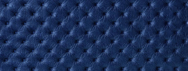 Texture of navy blue leather background with capitone pattern, macro. Vintage sapphire fabric backdrop.